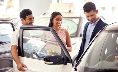 Image showing Couple at car dealership, choice and transport with salesman, people buying new transportation with luxury. Happy with decision, man and woman at automobile showroom with purchase and browsing cars