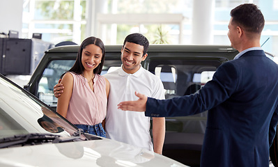 Image showing Couple at car dealership, choice and transportation with salesman, customer buying new transport with luxury. Sales, agreement and show cars with people at automobile showroom with purchase decision