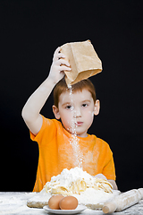 Image showing a boy dabbles with wheat flour