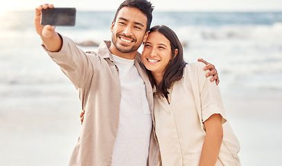 Image showing Couple at beach, selfie and travel with happiness outdoor, romantic holiday in Mexico with social media post and love. Trust, care and commitment, man and woman smile in picture with ocean and memory