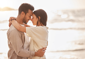 Image showing Couple hug at beach, forehead touch and travel with sun and sea, love and care with vacation in Mexico. Commitment, support and trust in relationship, tourism and people embrace with mockup space