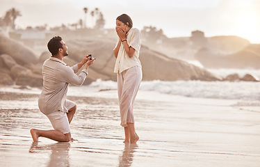 Image showing Couple at beach, surprise proposal and engagement with love and commitment with ocean and people outdoor. Travel, seaside and man propose marriage to woman, wow reaction and happiness with care