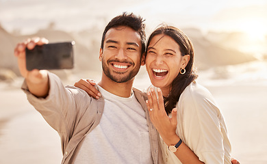 Image showing Engagement, selfie and couple with love, beach and bonding with happiness, celebration and romance. Commitment, man and woman on a seaside holiday, social media and proposal with a memory and travel