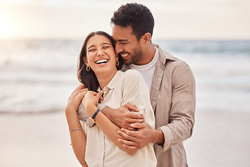 Image showing Together, beach and happiness with hug on holiday for having fun with sunset for the weekend. Couple, vacation and laughing with face at the ocean for travel in the summer for a relaxing time.