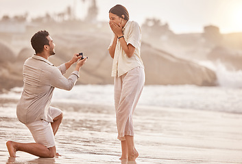 Image showing Couple at beach, wow for proposal and engagement with love and commitment with ocean and people outdoor. Travel, mockup space and man propose marriage to woman, surprise and happiness with care