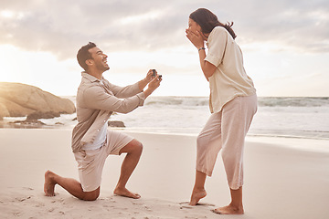 Image showing Couple, engagement proposal and surprise at beach with smile, happiness or love on vacation in sunset. Man, woman and ring with marriage offer by ocean with smile, excited face or together on holiday