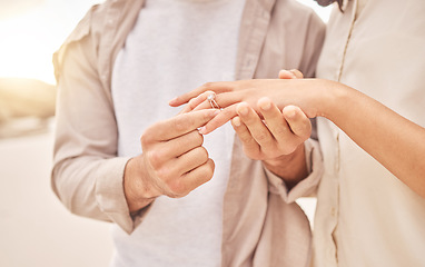 Image showing Couple, hands and engagement in closeup at beach with care, achievement or love on vacation in sunset. Man, woman and ring with marriage offer by ocean for proposal, future and together on holiday