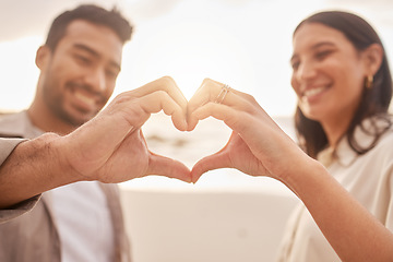 Image showing Heart hands, happy and a couple at the beach for love, date and travel together in Bali. Smile, emoji and a man and woman with a shape and hand gesture for romance, ocean holiday and bonding