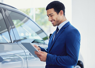 Image showing Tablet, car and salesman smile at showroom, workshop or salon workplace. Internet, technology and male person at dealership for motor vehicle shopping, web scroll and email app in auto retail store.