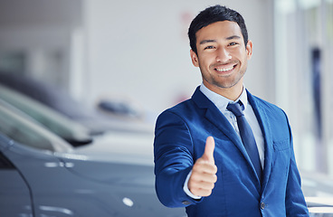 Image showing Portrait, thumbs up and car salesman smile at showroom for ok, yes and welcome. Face, like hand gesture and dealership manager with emoji for success, agreement or thank you for sales in retail store