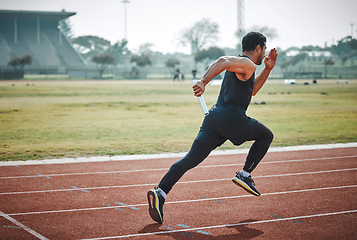 Image showing Stadium, man relay running and athlete on a runner and arena track for sprint race training. Fast, run and sports exercise of a male person in marathon for fitness and workout outdoor on a field