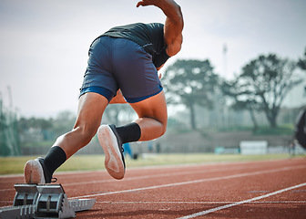 Image showing Stadium, man running and start block of athlete on a runner and arena track for sprint race training. Back, run and sports exercise of male person in marathon for fitness and workout outdoor on field