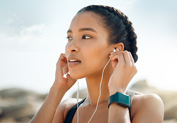 Image showing Woman with earphones, fitness at the beach and listening to music for motivation and workout outdoor. Exercise, health and wellness, female athlete streaming online with radio and audio in nature