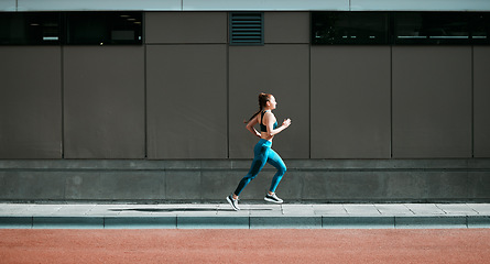 Image showing Young woman, running and city sidewalk with training, exercise and fitness on urban road. Street, runner profile and female athlete with mockup and body workout for health, wellness and race outdoor