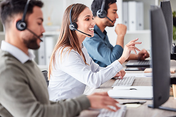 Image showing Woman, call center and working in office workspace with headset, computer and online customer support, service or help. Businesswoman, smile and contact us, crm and telemarketing employee talking