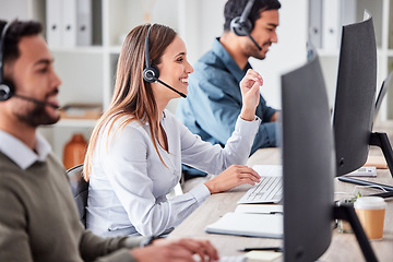 Image showing Call center, woman and working in team office with headset, computer and online customer support, service or help. Businesswoman, smile and contact us, crm and telemarketing employee talking