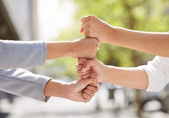 Image showing Fists, team building or business people in city for collaboration for mission goals in a deal. Motivation, fist bumping closeup or employees with goals together, teamwork or support outdoors in park