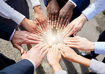 Image showing Hands, teamwork or top view of business people outside in collaboration for mission goals in city. Light, link or employees meeting with strategy, teamwork or support outdoors together in huddle