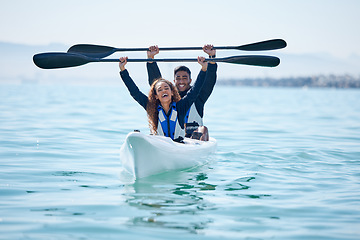 Image showing Kayak, sports and team celebrate win on rowing boat on a lake, ocean or river for fitness challenge. Man and woman or winning couple with a paddle for adventure, teamwork exercise or travel on water