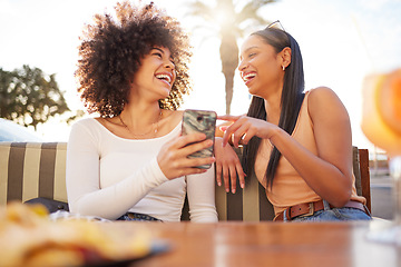 Image showing Laughing, happy and women with a phone at a cafe for a meme or social media notification. Smile, talking and friends with a mobile for a funny app, comic conversation or comedy together at restaurant