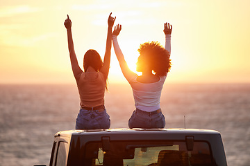 Image showing Sunset, women sitting on a car and at the beach with back view for carefree or peace. Freedom or adventure, summer vacation or holiday break and travel with female people at sea happy together