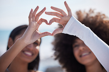 Image showing Friends, closeup and heart hands with women at beach for summer, happy and teamwork. Support, freedom and love with people and holding shape in outdoors for collaboration, faith and community gesture