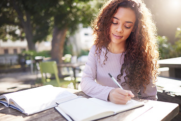 Image showing Writing, studying and woman with books outdoor in park, cafe or university campus, notes or exam goals. Planning, ideas and african person or college student for remote work, scholarship and notebook