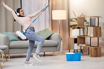 Image showing Dance, home and woman cleaning, music and happiness with energy, listening and headphones. Female person, girl and cleaner with a headset, mop and bucket in a lounge, streaming audio and housekeeping