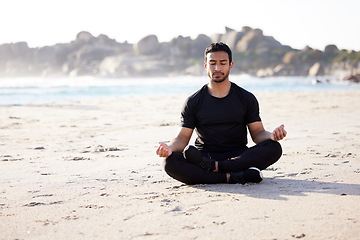 Image showing Freedom, man sitting on the beach and meditation for peace of mind during summer. Relax or harmony meditating, mental health and male person on the sea sand for health wellness in fresh air outdoors