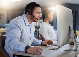 Image showing Call center, focus and computer with man in office for communication, customer service or help desk. Telemarketing, sales and advice with male employee for commitment, contact us and hotline