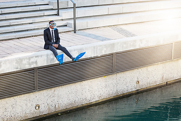 Image showing Businessman, travel and snorkel mask for holiday, ready for vacation and ocean adventure. Scuba, diving and man sitting at water, waves or excited for break from work, experience or summer trip