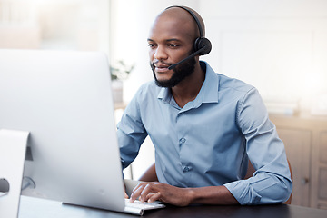 Image showing Black man, computer and call center, contact us and communication, concentrate with headset and connect. Male agent with focus, customer service or tech support, help desk employee is reading online