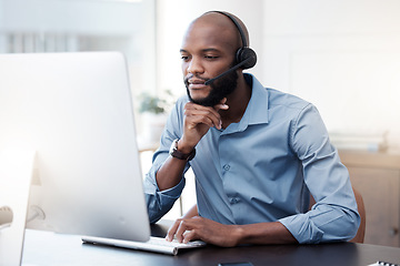 Image showing Black man, computer and call center, thinking with contact us and communication, concentrate with headset and connect. Male agent with focus, customer service and help desk employee is reading online