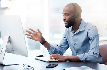 Image showing Black man at computer, callcenter and contact us, phone call communication with headset and talking. Male agent in office, customer service and help desk employee with tech support and discussion