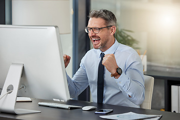 Image showing Happy, businessman and fist in celebration for winning, success or promotion by desk at office. Man employee in joy for win, achievement or bonus on computer in sale, discount or prize at workplace
