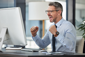 Image showing Happy, businessman and fist in celebration for promotion, winning or success by desk at the office. Man employee in joy for win, achievement or bonus on computer in sale, target or prize at workplace