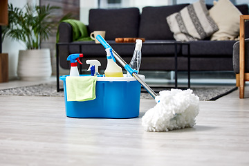 Image showing Cleaning, bacteria and mop on the floor of a living room in a home for hygiene or service during housework. Product, detergent and safety with supplies in a bucket ready to clean a house for service