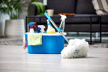 Image showing Cleaning, detergent and mop on the floor of a living room in a home for hygiene or service during housework. Product, bacteria and safety with supplies in a bucket ready to clean a house for service