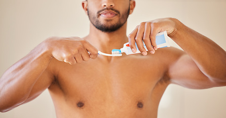 Image showing Hands, toothpaste on toothbrush with man and dental, oral health and wellness with brushing teeth. Fresh breath, hygiene and grooming with male person cleaning mouth, self care and morning routine