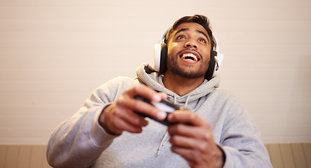 Image showing Man play video games, headphones and controller for esports, online streaming and happy at home. Male gamer, smile with entertainment and excited about gaming competition, tech and cyber streamer