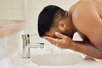 Image showing Man washing face, water splash and beauty in bathroom, skincare and cleaning skin with water for morning routine. Male person at home, grooming and natural cosmetic care, clean facial and hygiene