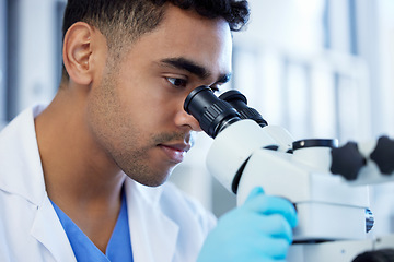 Image showing Science, innovation and a man with microscope in a lab for medical research and analysis. Serious, medicine and a scientist doing a check of chemistry, microbiology or a virus working at a clinic