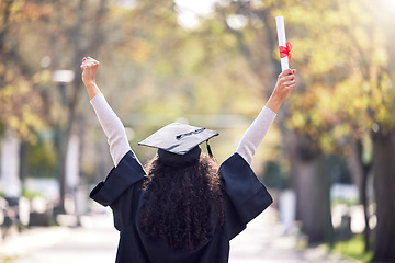 Image showing Graduation, back and woman student celebrating academic success or raising her diploma or victory at university campus with cheers. Motivation, certificate and achievement for happy female person