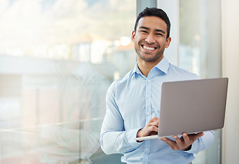 Image showing Businessman, smile portrait and laptop at office window with internet connection and career pride. Happy asian male entrepreneur with technology, internet and space for networking, email and work