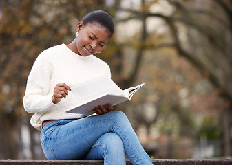 Image showing Woman, reading and notebook in the outdoor at university for knowledge and research at school. Female student, book and learning at the park for an education with a scholarship for motivation.