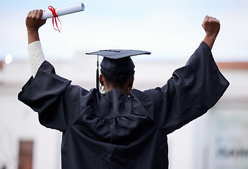 Image showing Back, education and black woman with graduation, celebration and success with a diploma. Female person, graduate and girl with a degree, achievement and university with a certificate and knowledge