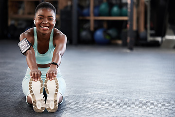 Image showing Music, portrait or happy girl in gym stretching legs for fitness workout or body movement with audio. Streaming radio, headphones or black woman smiling in exercise training warm up for flexibility