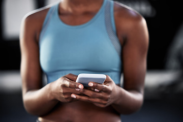 Image showing Smartphone, hands or woman in gym on social media to relax on fitness or exercise or workout break. Athlete closeup, texting or girl with mobile app for online digital communication after training