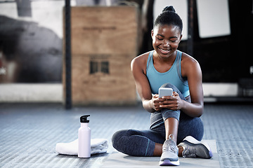 Image showing Smartphone, happy or black woman in gym on social media to relax on fitness or exercise or workout break. Athlete, meme or funny girl with mobile app for online digital communication after training