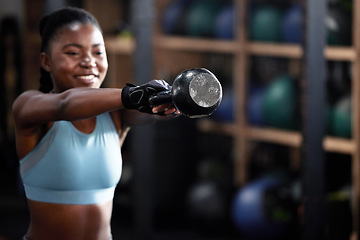 Image showing Fitness, kettlebell or happy black woman in training, workout or bodybuilding exercise for grip strength power. Body builder, smile or strong African sports athlete with at gym lifting heavy weights